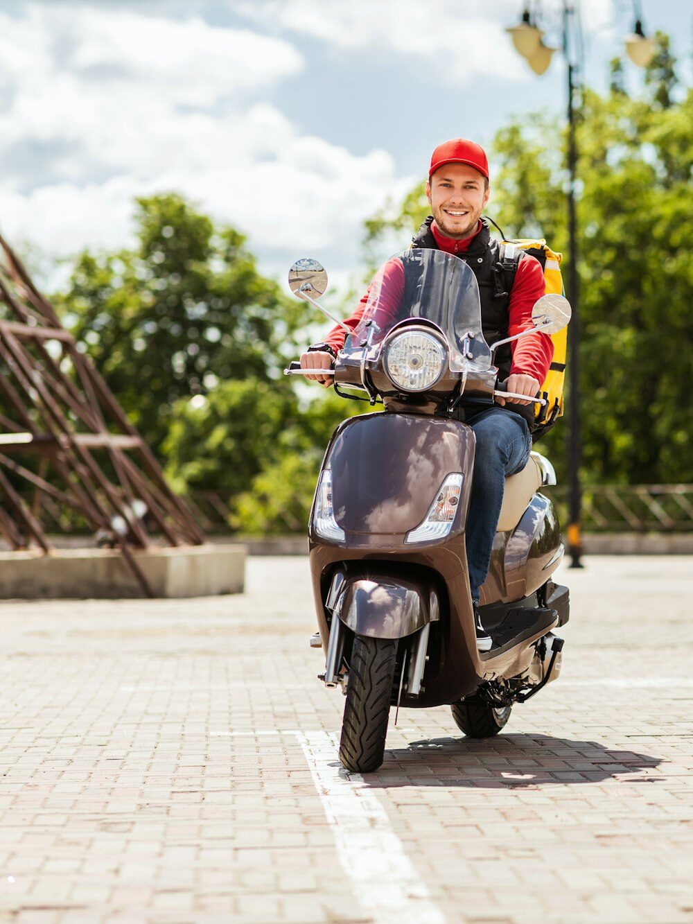 Courier Guy With Backpack Riding Scooter Delivering Food In City